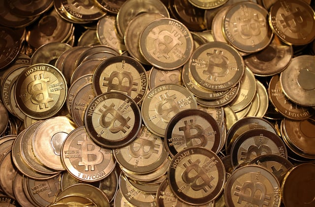 A pile of Bitcoin slugs sit in a box ready to be minted by Software engineer Mike Caldwell in his shop on April 26, 2013 in Sandy, Utah. (Photo by George Frey/Getty Images)