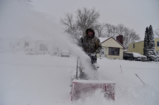 Jayson MacDonald clears lake effect snow outside of his home on January 21, 2025 in Hamburg, New York.