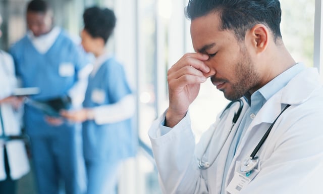Asian man, doctor and anxiety in burnout, grief or mistake against glass window in hospital building. Frustrated physician, medical healthcare and person in stress, loss or headache at clinic