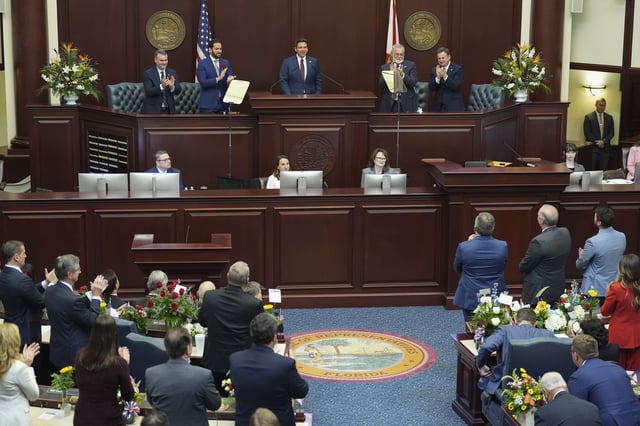 Lawmakers applaud as Florida Gov. Ron DeSantis, center, gives his State of the State address to a joint session on the opening day of the 2025 legislative session, Tuesday, March 4, 2025, at the state capitol in Tallahassee, Fla. (AP Photo/Rebecca Blackwell)