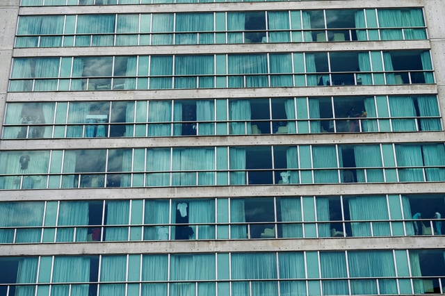 People look out from a hotel where migrants from Asia and the Middle East are housed after being deported to Panama as part of an agreement between the administration of U.S. President Donald Trump and the Central American nation, in Panama City, Panama February 18, 2025.