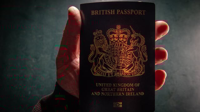 BATH, UNITED KINGDOM - FEBRUARY 2:  In this photo illustration, a man holds a post-Brexit United Kingdom issued passport on February 2, 2025 in Bath, England.