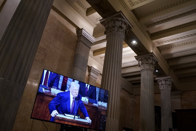 U.S. President Donald Trump delivers a speech to a joint session of Congress, as seen on a screen at the U.S. Capitol in Washington, D.C., U.S., March 4, 2025. REUTERS/Nathan Howard