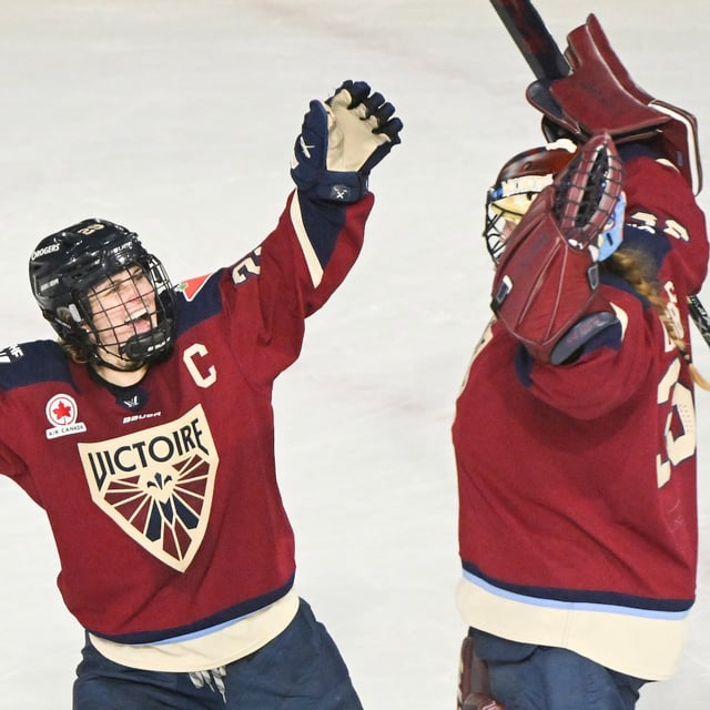 Montreal Victoire goaltender Ann-Renee Desbiens, right, celebrates with teammate Marie-Philip Poulin after defeating the Minnesota Frost in a PWHL hockey game in Laval, Que. Tuesday, March 4, 2025. THE CANADIAN PRESS/Graham Hughes