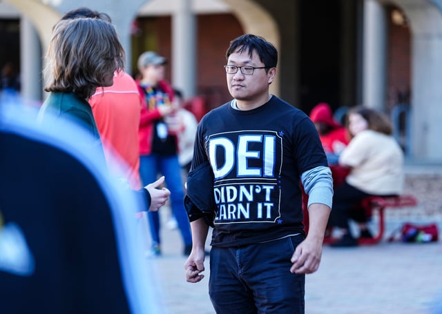 A lone student wore an anti-DEI support T-shirt that read "DEI Didn't Earn It" before a rally to protect DEI in America Friday at the University of Louisville campus in Louisville, Kentucky Feb. 28, 2025