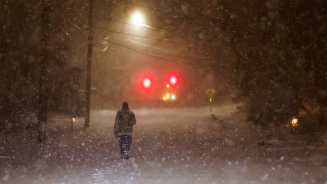 A man walks along an empty road during the pass of a polar vortex in Norwood, New Jersey, U.S.
