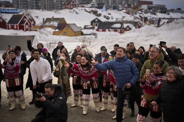 Relatives and family members throw rice at Salik and Malu Schmidt as they leave the church of our Savior after getting married in Nuuk, Greenland, Saturday, Feb. 15, 2025. (AP Photo/Emilio Morenatti)
