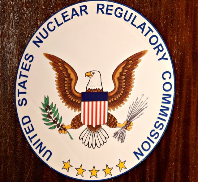 The logo of the U.S. Nuclear Regulatory Commission is shown on the podium during a public meeting in Carlsbad, California September 26, 2013.  REUTERS/Mike Blake/File Photo
