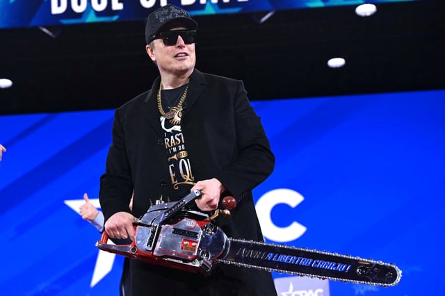 Elon Musk holds a chainsaw reading &#34;Long live freedom, damn it&#34; during the annual Conservative Political Action Conference (CPAC) at the Gaylord National Resort &amp; Convention Center at National Harbor in Oxon Hill, Maryland, on February 20, 2025.