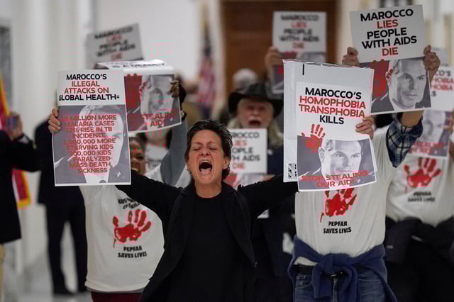 Protesters hold placards as Pete Marocco, deputy administrator-designate at the U.S. Agency for International Development (USAID), attends a meeting with members of Congress to discuss foreign assistance, on Capitol Hill in Washington, D.C., U.S. March 5, 2025.