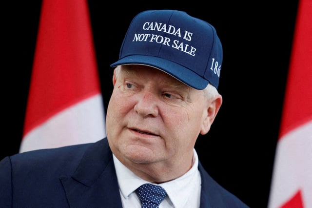 Ontario Premier Doug Ford, wearing a "Canada is not for sale" hat, speaks to journalists at a provincial and territorial leaders meeting in Ottawa, Ontario, Canada January 15, 2025.