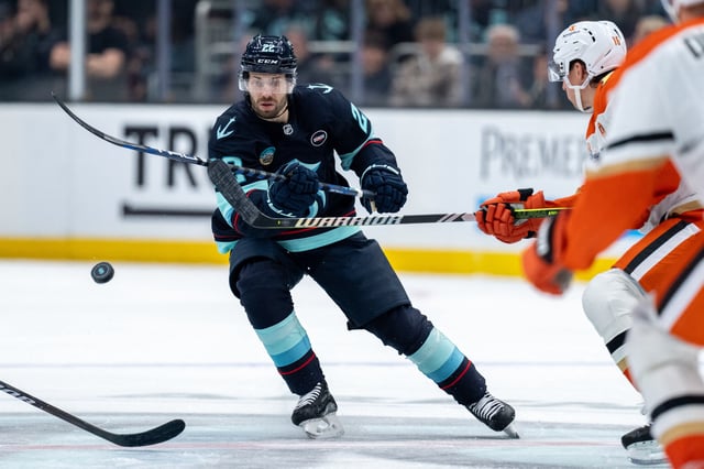 Jan 28, 2025; Seattle, Washington, USA;  Seattle Kraken forward Oliver Bjorkstrand (22) dumps the puck during the second period against the Anaheim Ducks at Climate Pledge Arena. Mandatory Credit: Stephen Brashear-Imagn Images/FIle Photo