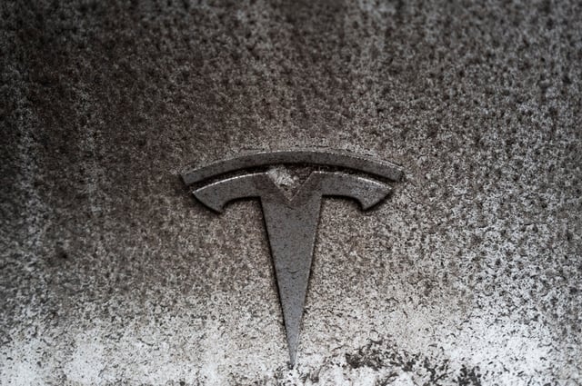 The Tesla logo is pictured on an electric car outside a petrol station in Pyhatunturi, Finland, February 24, 2025. REUTERS/Gonzalo Fuentes