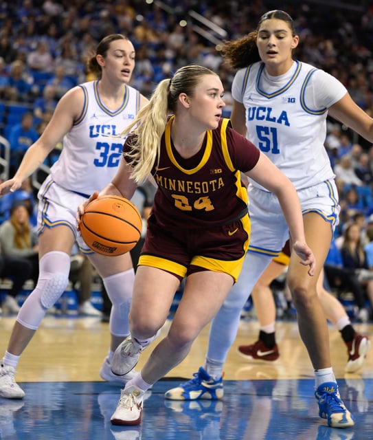 Feb 2, 2025; Los Angeles, California, USA; Minnesota Golden Gophers forward Mallory Heyer (24) moves the ball past UCLA Bruins forward Angela Dugalic (32) and UCLA Bruins center Lauren Betts (51) during the second quarter at Pauley Pavilion presented by Wescom. Mandatory Credit: Robert Hanashiro-Imagn Images