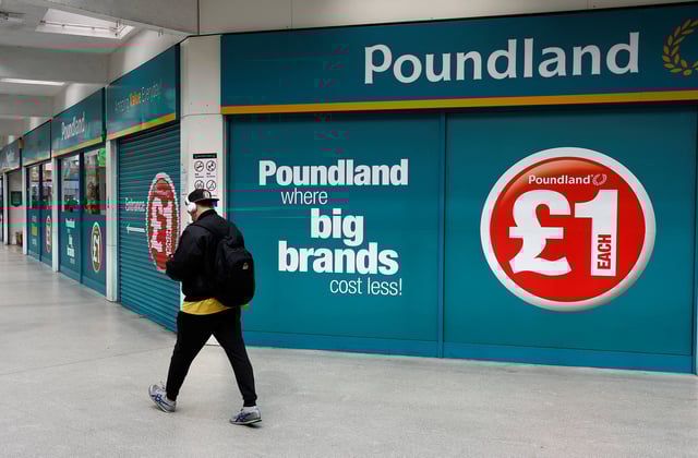 A man walks past a Poundland store in London, Britain, April 16 2023.  REUTERS/Peter Nicholls/File Photo