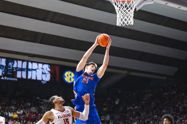 Mar 5, 2025; Tuscaloosa, Alabama, USA; Florida Gators forward Alex Condon (21) shoots against Alabama Crimson Tide forward Jarin Stevenson (15) during the first half at Coleman Coliseum. Mandatory Credit: Will McLelland-Imagn Images