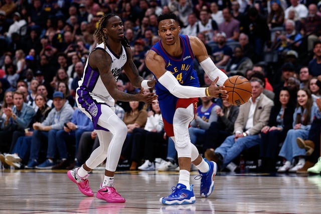Mar 5, 2025; Denver, Colorado, USA; Denver Nuggets guard Russell Westbrook (4) controls the ball as Sacramento Kings guard Keon Ellis (23) guards in the fourth quarter at Ball Arena. Mandatory Credit: Isaiah J. Downing-Imagn Images