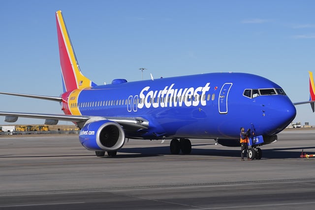 Southwest Airlines jetliner is checked by a ramp worker after backing out of a gate on the C concourse at Denver International Airport Thursday, Feb. 27, 2025, in Denver.