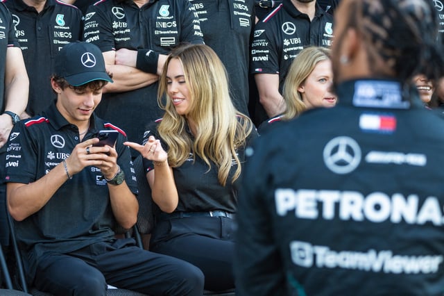 Mercedes&#39; Italian teenage driver Andrea Kimi Antonelli (L), who will be replacing British driver Lewis Hamilton (R), arrives to pose for a group photo with their team ahead of the Abu Dhabi Formula One Grand Prix at the Yas Marina Circuit in Abu Dhabi on December 5, 2024.