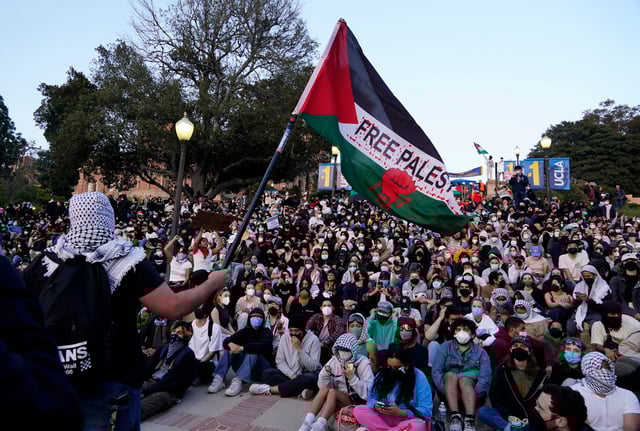 May 1, 2024; Los Angeles, California, USA; A flag is waved during a sit-in outside of a pro-Palestinian encampment at the campus of UCLA. Violence broke out early in the morning at the encampment, hours after the university declared that the camp “is unlawful and violates university policy.”