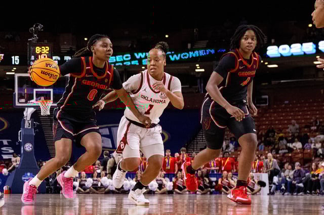 Mar 6, 2025; Greenville, SC, USA; Georgia Lady Bulldogs guard Trinity Turner (0) drives on Oklahoma Sooners guard Nevaeh Tot (1) during the first half at Bon Secours Wellness Arena. Mandatory Credit: Scott Kinser-Imagn Images