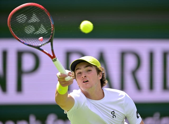 Mar 6, 2025; Indian Wells, CA, USA;  Joao Fonseca (BRA) hits a shot during his first round match as he defeated Jacob Fearnley (not pictured) in the BNP Paribas Open at the Indian Well Tennis Garden. Mandatory Credit: Jayne Kamin-Oncea-Imagn Images