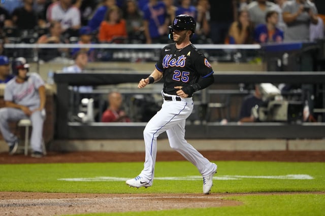 Sep 2, 2022; New York City, New York, USA; New York Mets right fielder Tyler Naquin (25) scores a run on New York Mets third baseman Eduardo Escobar (10) (not pictured) sacrifice fly ball against the Washington Nationals during the sixth inning at Citi Field. Mandatory Credit: Gregory Fisher-USA TODAY Sports/File Photo