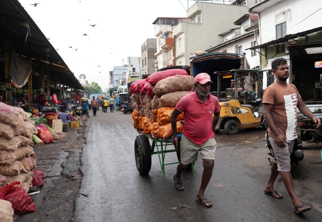 A man pulls a cart as he transports sacks filled with potatoes at a market in Colombo, Sri Lanka, November 23, 2024. REUTERS/Thilina Kaluthotage/File Photo