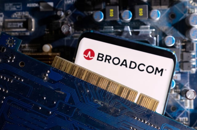 A smartphone with a displayed Broadcom logo is placed on a computer motherboard in this illustration taken March 6, 2023. REUTERS/Dado Ruvic/Illustration/File Photo