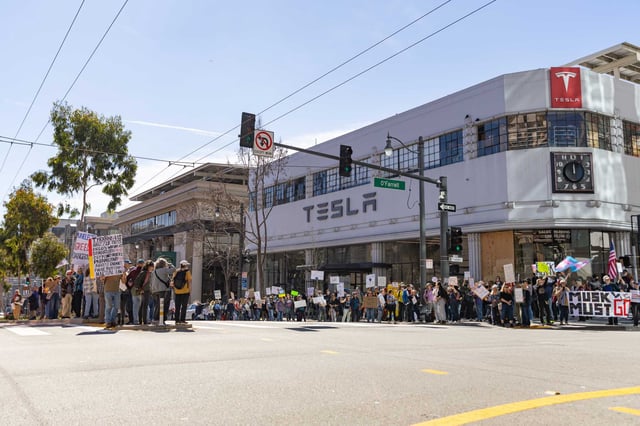 People gather to protest outside Tesla San Francisco in February. The protests have draw people who want to draw attention to their disgust at how Tesla CEO Elno Musk is operating inside the Trump administration.