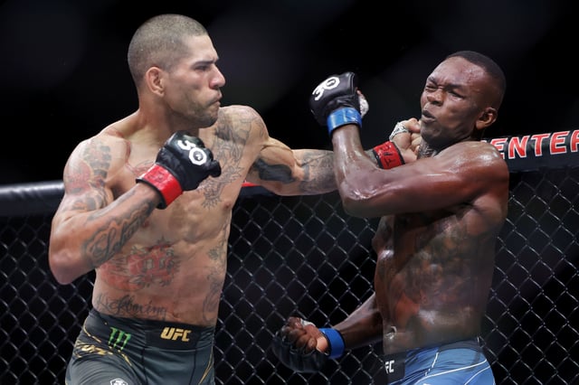 Alex Pereira (L) of Brazil punches Israel Adesanya of Nigeria in their middleweight title bout during UFC 287 at Kaseya Center on April 08, 2023 in Miami, Florida
