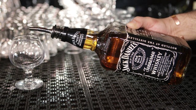 In this March 4, 2011, file photo, a bartender begins to pour a drink from a bottle of Jack Daniels at a bar in San Francisco. (