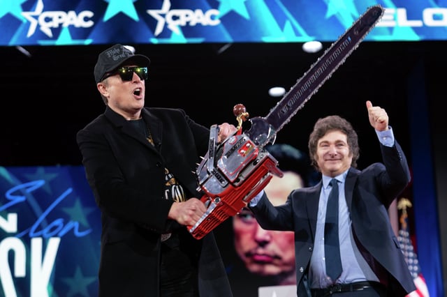 Elon Musk holds a chainsaw handed to him by Argentine President Javier Milei, behind, at the Conservative Political Action Conference (CPAC) in Oxon Hill, Maryland, Feb. 20, 2025. The chainsaw is meant to symbolize cuts within the federal government as Musk and the Department of Government Efficiency aim to reduce government spending. 