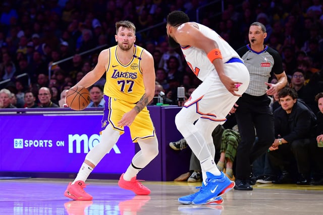 Mar 6, 2025; Los Angeles, California, USA; Los Angeles Lakers guard Luka Doncic (77) moves the ball against New York Knicks center Karl-Anthony Towns (32) during the second half at Crypto.com Arena. Mandatory Credit: Gary A. Vasquez-Imagn Images/File Photo