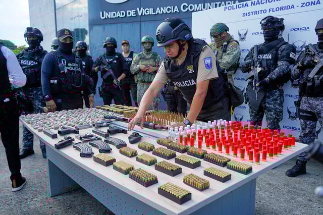 Police display to the press the weapons they say they seized in an operation related to the previous day's massacre in Guayaquil, Ecuador, Friday, March 7, 2025. (AP Photo/Cesar Munoz)