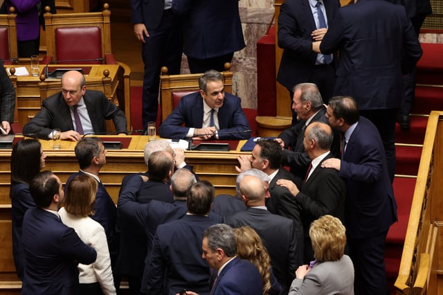Greek prime minister Kyriakos Mitsotakis talks with his party's lawmakers, after the results of  no-confidence motion against his government at the parliament in Athens, Greece, March 7, 2025. REUTERS/Stelios Misinas