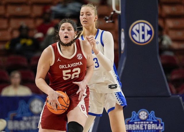 Mar 7, 2025; Greenville, SC, USA; Oklahoma Sooners center Raegan Beers (52) handles the ball defended by Kentucky Wildcats center Clara Strack (13) during the second half at Bon Secours Wellness Arena. Mandatory Credit: Jim Dedmon-Imagn Images