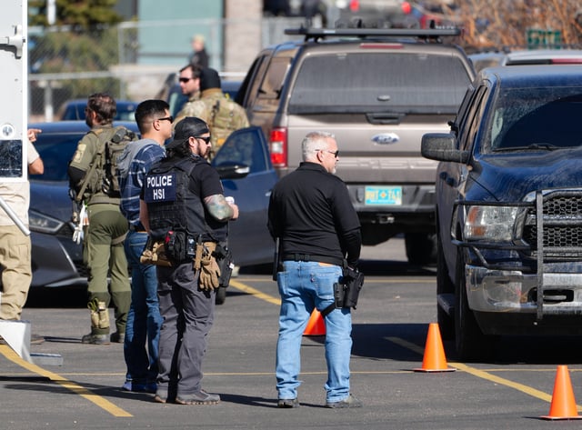 Federal agents at a staging area in Denver following immigration raids on Wednesday, Feb. 5, 2025.