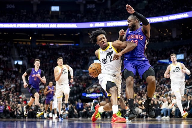 Utah Jazz guard Collin Sexton (2) drives towards the net while defended by Toronto Raptors guard Jamal Shead (23) during first half NBA basketball action, in Toronto on Friday, March 7, 2025. THE CANADIAN PRESS/Christopher Katsarov
