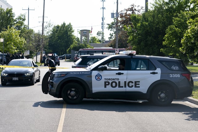 Toronto police officers respond to a deadly shooting in north Toronto, Monday, June 17, 2024. (Arlyn McAdorey/The Canadian Press via AP)