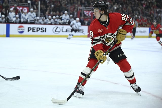 Mar 7, 2025; Chicago, Illinois, USA;  Chicago Blackhawks center Connor Bedard (98) moves the puck against the Utah Hockey Club during the first period at the United Center. Mandatory Credit: Matt Marton-Imagn Images