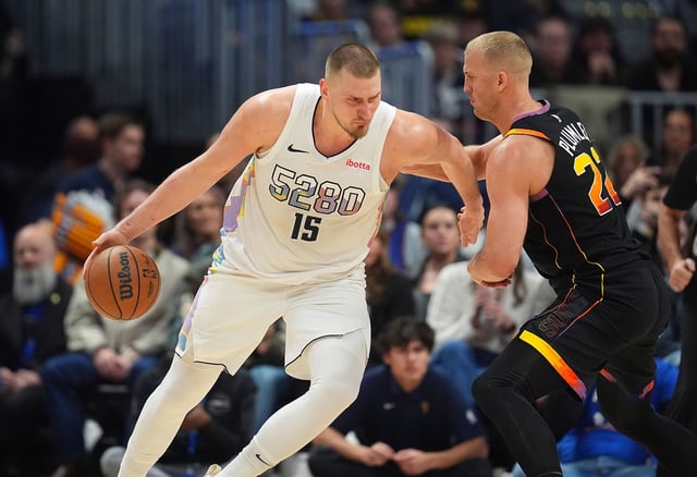 Denver Nuggets center Nikola Jokic, left, drives to the basket against Phoenix Suns center Mason Plumlee during an NBA basketball game in Denver, on Friday.