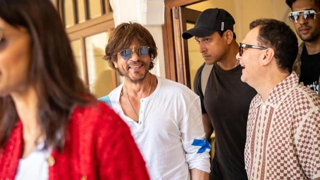 Actor Shah Rukh Khan arrives at the hotel for IIFA 2025. He is seen flashing a big smile as the IIFA team clicks his pictures.