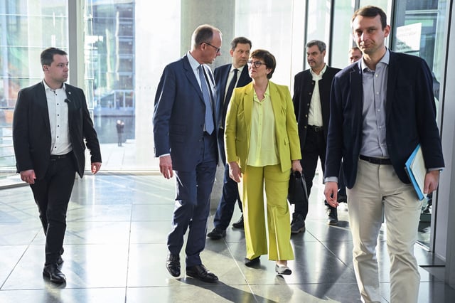 Germany's chancellor-in-waiting and leader of the Christian Democratic Union party (CDU) Friedrich Merz speaks with co-leader of the Social Democratic party (SPD) Saskia Esken as they leave after giving a statement with Bavarian state premier and leader of the Christian Social Union (CSU) Markus Soeder and co-leader of the Social Democratic party (SPD) Lars Klingbeil, after exploratory talks, in Berlin, Germany March 8, 2025. REUTERS/Annegret Hilse