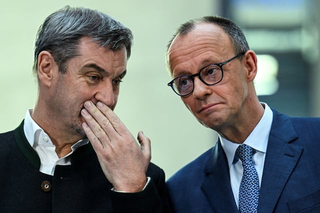 Germany's chancellor-in-waiting and leader of the Christian Democratic Union party (CDU) Friedrich Merz speaks with Bavarian state premier and leader of the Christian Social Union (CSU) Markus Soeder as they give a statement with co-leaders of the Social Democratic party (SPD) Saskia Esken and Lars Klingbeil, after exploratory talks in Berlin, Germany March 8, 2025. REUTERS/Annegret Hilse