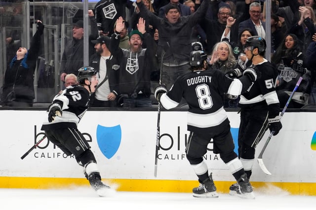 Kings right wing Quinton Byfield, right, celebrates with teammates defenseman Brandt Clarke, left, and defenseman Drew Doughty after scoring a game-winner during overtime of an NHL hockey game against the St. Louis Blues, Saturday, March 8, 2025, in Los Angeles. (AP Photo/Mark J. Terrill)