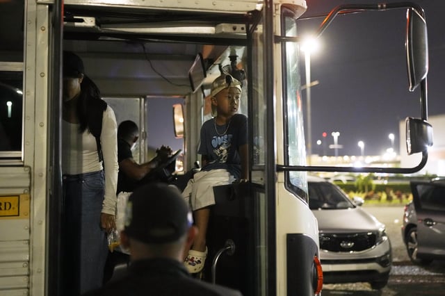 A Vietnamese boy traveling with his mother and other migrants who were held in a Panamanian immigration camp after their deportations from the U.S. arrives in Panama City, Saturday, March 8, 2025, after authorities gave them 30 days to leave the country. (AP Photo/Matias Delacroix)