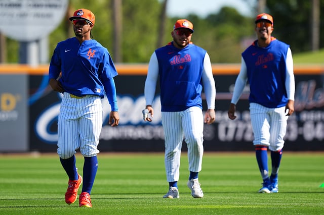Francisco Lindor #12, Francisco Alvarez #4 and Mark Vientos #27 of the New York Mets look on during spring training workouts at Clover Park on February 17, 2025 in Port St. Lucie, Florida.