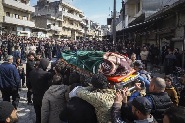 Relatives and neighbours attend funeral procession for four Syrian security force members killed in clashes with loyalists of ousted President Bashar Assad in coastal Syria, in the village of Al-Janoudiya, west of Idlib, Saturday, March 8, 2025. (AP Photo/Omar Albam)