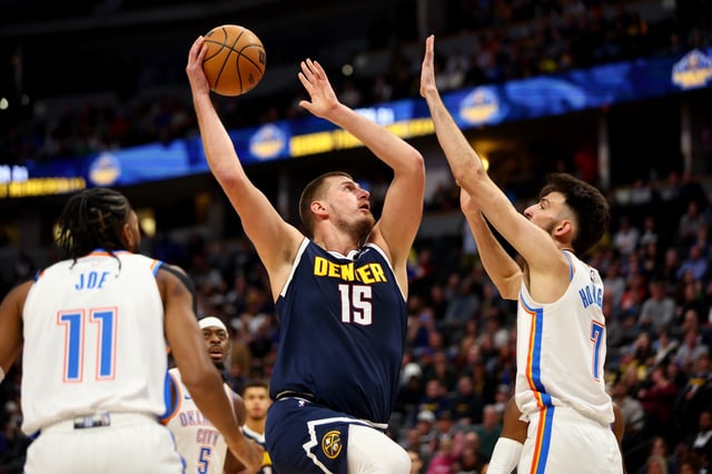 Nikola Jokic #15 of the Denver Nuggets drives against Chet Holmgren #7 of the Oklahoma City Thunder in the first quarter at Ball Arena on November 6, 2024 in Denver, Colorado.